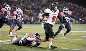 Northern Illinois quarterback Jordan Lynch eludes UT's Cheatham Norrils. Lynch threw for 202 yards and rushed for 161.