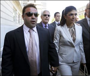 'The Real Housewives of New Jersey' stars Giuseppe 'Joe' Giudice, left, and his wife, Teresa Giudice, of Montville Township, N.J., walk out of Martin Luther King Jr. Courthouse after an appearance in Newark, N.J. in July.