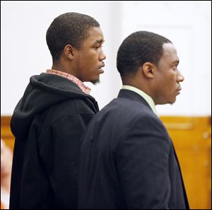 Carl Steward, 21, of Toledo, left, with attorney Phil Carlisle, appears before Lucas County Judge Gary Cook as Steward is sent to jail for five dog-fighting convictions, all felonies.