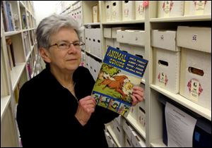 Maggie Thompson poses with ‘Animal Comics’ in the addition to her Wisconsin home that houses her tens of thousands of comic books. Thompson has put about 500 of her most treasured issues up for auction, including copies of  ‘Journey Into Mystery’ No. 83 and the first issue of ‘The Avengers.’
