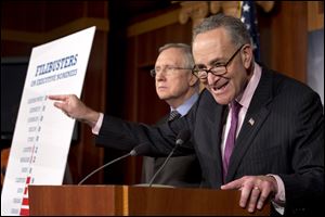 Democratic Sen. Charles Schumer of New York right, gestures while speaking next to Senate Majority Leader Harry Reid, of Nevada, during a news conference after the Democrat majority in the Senate pushed through a major rules change.
