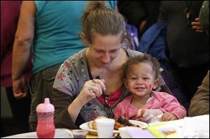 A’naysia Scott, 15 months, and her mother Mary Cervantez,enjoy lunch during the event at Holy Trinity Greek Orthodox Church.