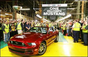 Ford’s Flat Rock Assembly Plant employees cheer as the millionth Ford Mustang is driven off the assembly line in Flat Rock, Mich., in April. The 2015 Mustang is to be unveiled simultaneously in six cities on four continents on Dec. 5.