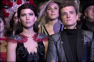 Jennifer Lawrence as Katniss Everdeen, left, and Josh Hutcherson as Peeta Mellark in a scene from 'The Hunger Games: Catching Fire.'