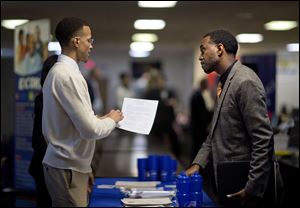 Retired U.S. Air Force Master Sgt. Thomas Gipson, of Atlanta, right, has his resume looked over by Ralph Brown, a management and program analyst with the Centers for Disease Control and Prevention, during a job fair for veterans at the VFW Post 2681, in Marietta, Ga. earlier this month.