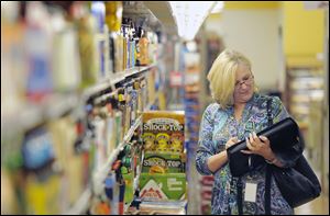 Caren Gaffney, an economic assistant with the U.S. Bureau of Labor Statistics, checks prices at a Virginia grocery store.