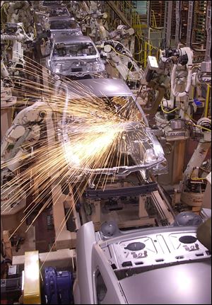 Robots weld the frames of Ford Mustangs at the company’s facility in Flat Rock, Mich. The plant builds another popular car for Ford, the Fusion.