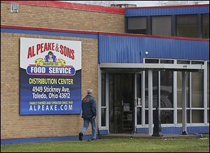 Daniel Dever, a special agent with the Internal Revenue Service, enters Al Peake & Sons Food Service, 4949 Stickney Ave. IRS and FBI agents raided the business Friday.