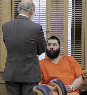 Attorney Alan Konop, left, speaks with Brian Steinmiller during his sentencing at the Wood County Courthouse in Bowling Green.