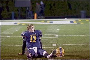 Bryan’s Austin Schimmoeller sits dejected after the game. He threw for 370 yards and three touchdowns and ran for three TDs.