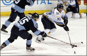 The Walleye's Alden Hirschfeld  and Evansville's Nathan Moon fight for the puck.