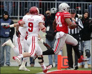 Ohio State RB Carlos Hyde (34) scores a touchdown against Indiana safety Greg Heban (9) during the first quarter of a football game Saturday.