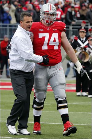Ohio State's Jack Mewhort (74) is greeted by head coach Urban Meyer during senior day.