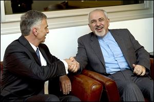 Switzerland’s Foreign Minister Didier Burkhalter, left, talks with Mohammad-Javad Zarif, Iranian foreign minister, before negotiations.