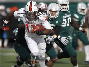 Bowling Green’s Travis Greene is chased by Eastern Michigan defenders. Greene rushed for 126 yards and two touchdowns for BG.