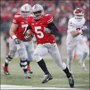 Ohio State’s Braxton Miller scores a touchdown against Indiana during the first  quarter. He threw for two scores and ran for two others. The Buckeyes improved to 11-0 on the season.