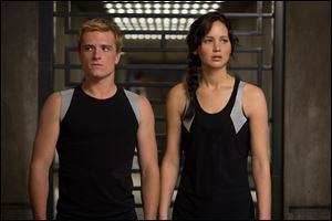 This image released by Lionsgate shows Josh Hutcherson as Peeta Mellark, left, and Jennifer Lawrence as Katniss Everdeen in a scene from 