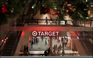 Holiday trimmings greet shoppers around the main entry of a Target on Saturday in New York. 