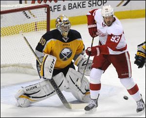 Sabres goaltender Ryan Miller reacts as Detroit Red Wings right winger Johan Franzen tries to deflect the puck Sunday in Buffalo, N.Y.