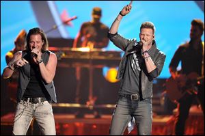 Tyler Hubbard, left, and Brian Kelley of Florida Georgia Line, above, perform. Katy Perry, at right, opens the show with a Japanese-inspired performance.