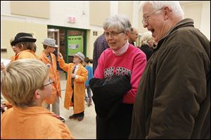 Gavin Losey, left, explains the lego robot competition to his grandparents Pat Stoll, center, and Andy Stoll, right.