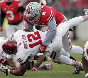 Ohio State linebacker Ryan Shazier, top, tackles Indiana running back Stephen Houston during the Buckeye's game on Saturday.