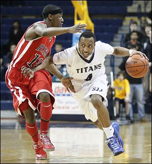 Anthony Glover of St. John’s drives past  Rogers' Clemmye Owens. Glover is one of the top area players returning this season.