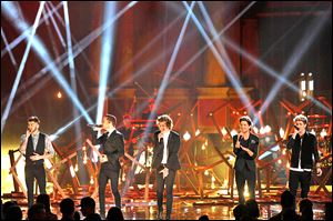 From left, Zayn Malik, Liam Payne, Harry Styles, Louis Tomlinson, and Niall Horan of the musical group One Direction perform on stage at the American Music Awards on Sunday.