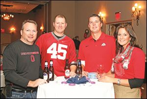 Left to right Rod Bowe, Dan Diekman, Ryan Heckel, and Stacy Heckel during the Epilepsy Center tailgate party Thursday, 11/14/13, at the Hilton Garden Inn in Perrysburg, Ohio.