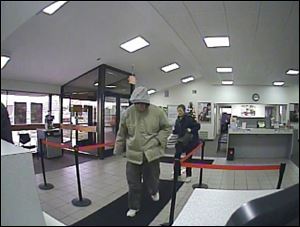 The suspect is described as a white male, 50s to 60s in age. He was approximately 6 foot, or slightly taller, with a medium build. He was wearing a tan coat, gray hooded sweatshirt, dark gray pants, white tennis shoes, and sunglasses. The man had gray facial hair estimated to be only a few days old.