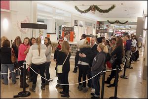 Customers wait to get into Pink, a clothing store in the Franklin Park mall, one of the retailers that opened on Thanksgiving evening for holiday shopping.