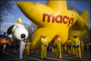 Balloon handlers wait before the 87th Annual Macy's Thanksgiving Day Parade, today in New York