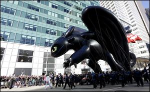 Tootheless the dragon balloon from the movie 'How To Train Your Dragon' is flown low because of wind activity during the Macy's Thanksgiving Day Parade.