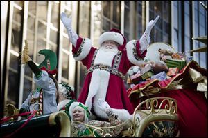 Santa Claus waves to the crowd during the 87th Annual Macy's Thanksgiving Day Parade.