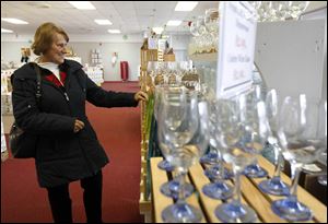 Ruth Frazier of Toledo looks at glassware at Libbey Glass’ seasonal store in the Starlite Plaza in Sylvania. Libbey decided to open the site to capitalize on the number of shoppers in the western suburbs. The Monroe Street location will be open through Dec. 29.