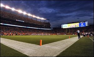 Sports Authority Field at Mile High stands under the lights during a preseason NFL football game between the Denver Broncos and the Arizona Cardinals in Denver. 