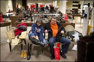 Lorice and Marc Pullins of Chicago shop for shoes on Black Friday at Macy’s  in Chicago. Black Friday savings also attract ‘self-gifters,’ people who jump on two-for-one deals to buy items for themselves.