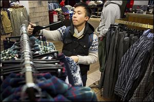 Kevin Zeng of Milwaukee, Wis., shops for clothing on Black Friday at Macy's in Chicago.