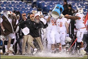 Bowling Green coach Dave Clawson gets a cold bath in celebration during the closing seconds of a victory over Buffalo at Ralph Wilson Stadium for the MAC East championship. The Falcons will play Northern Illinois on Friday for the confernce championship.
