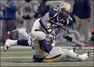 Akron linebacker Justin March sacks Toledo quarterback Terrance Owens in the second quarter.