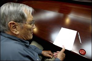 U.S. citizen Merrill Newman, 85, applies his thumb print to a document which North Korean authorities say was an apology which Newman wrote and read in North Korea. 