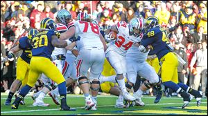 Ohio State running back Carlos Hyde scores the final touchdown for the Buckeyes against Michigan. Hyde ran for 226 yards against the Wolverines, a school record for the UM game.