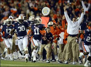Auburn cornerback Chris Davis (11) returns a missed field-goal attempt more than 100 yards for a touchdown on the final play against Alabama in Auburn, Ala..