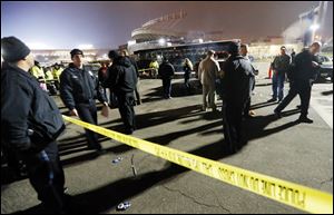 Kansas City, Mo. police work a crime scene in parking lot A outside Arrowhead Stadium, in Kansas City, Mo., after a person was killed Sunday.