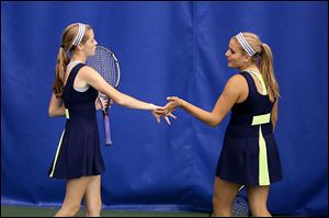 Notre Dame’s Teagan McNamara, left, and Alicia Nahhas celebrate a point at the state tournament. They finished fourth in Division I doubles.