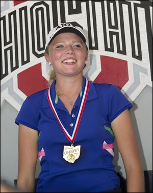 Lakota junior Makayla Dull accepts her medal after winning the Division II state girls title.