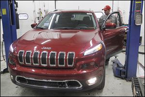 Mechanic Joe Ziegler prepares a 2014 Cherokee for the sales lot at Yark Jeep in Toledo.