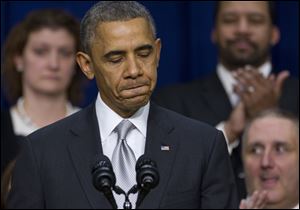 President Barack Obama pauses as he speaks about the new health care law.
