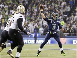 Seattle Seahawks quarterback Russell Wilson (3) throws against the New Orleans Saints in the first half .