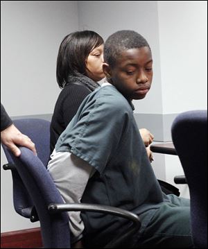 Louis Stroude, 14, and his mother, Lonyel Cole, await his hearing in Juvenile Court. Police said Louis had a pellet gun and a knife in his bookbag at Scott High School. the freshman was charged with making terrorist threats and illegal conveyance of a dangerous weapon onto school property.